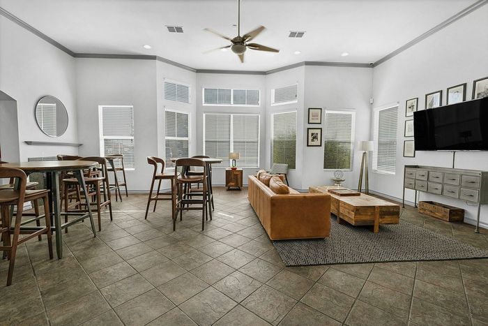 Resident clubhouse with plenty of seating and tvs