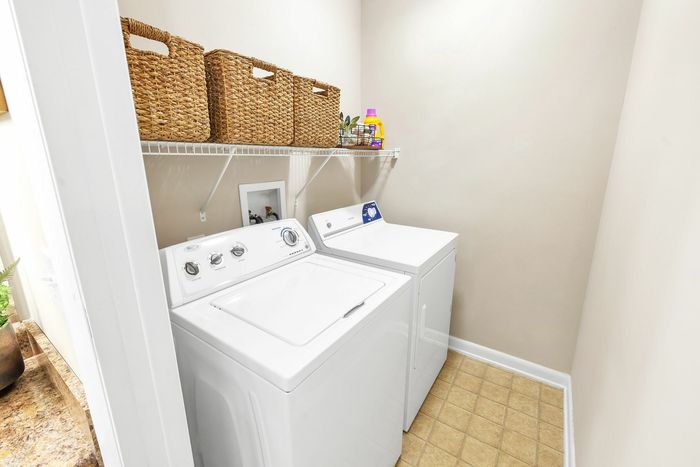 In-unit laundry area with washer and dryer at Eagles West Apartments in Auburn, AL.