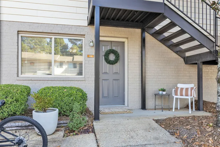 Exterior view of Eagles West Apartments with resident parking in Auburn, AL.