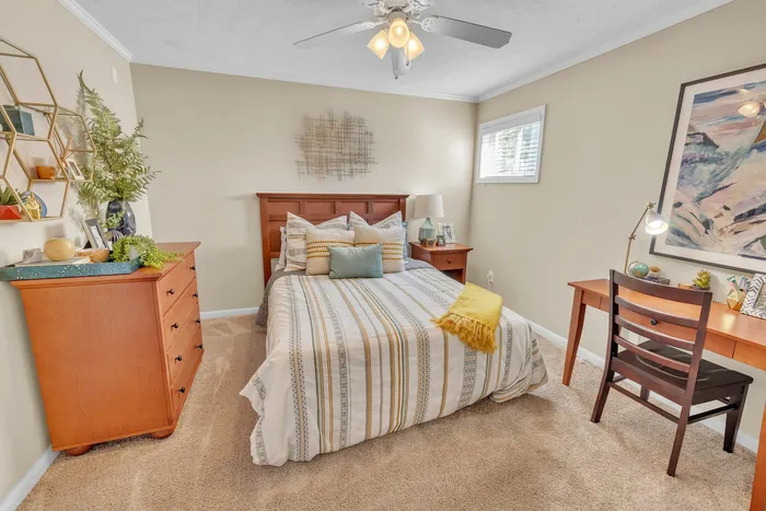 Cozy bedroom with modern decor and study desk at Eagles West Apartments in Auburn, AL.