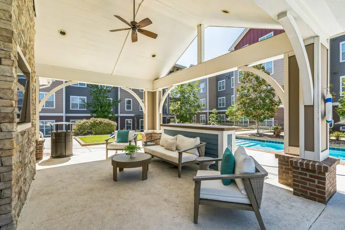 Resort-style pool with shaded outdoor lounge at The Flatts Starkville student apartments near MSU.