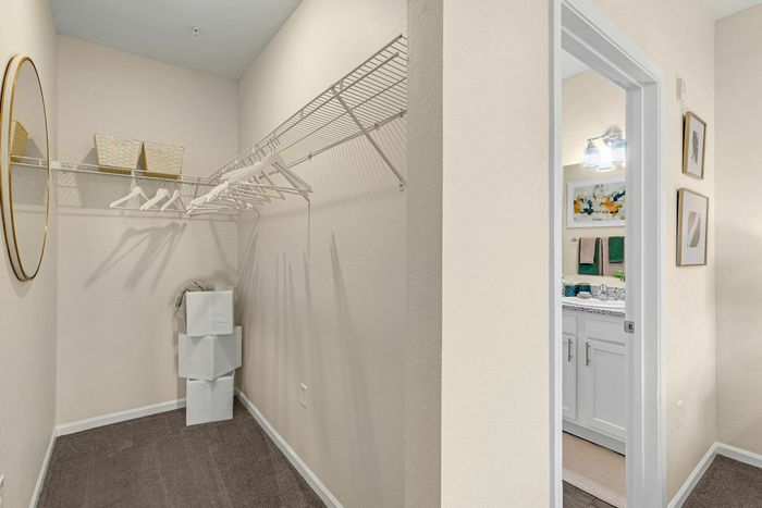 Spacious walk-in closet and bathroom in a student apartment at The Flatts Starkville