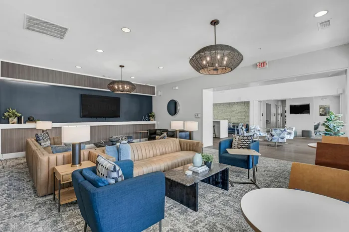Modern resident lounge with seating and bar area at The Flatts Starkville near MSU.