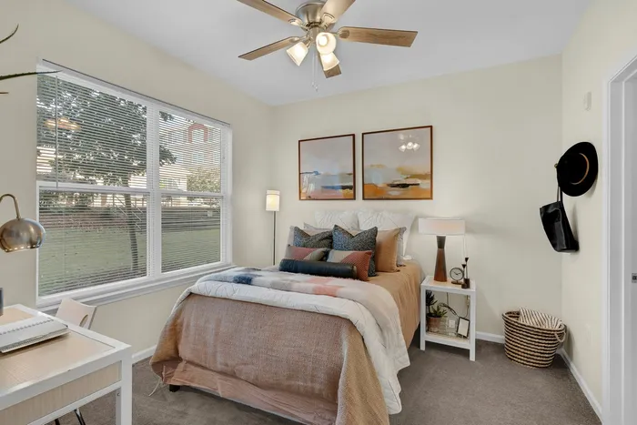 Comfortable bedroom with walk-in closet and bathroom in a student apartment at The Flatts Starkville