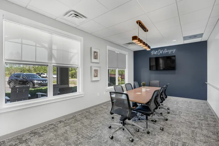 Private multi media room with TV and long conference table