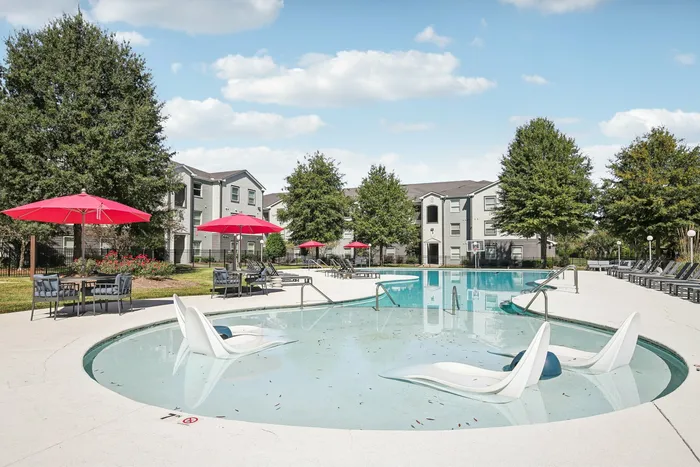Resort-style outdoor pool with lounge chairs and sunbathing area at The Preserve Murfreesboro.