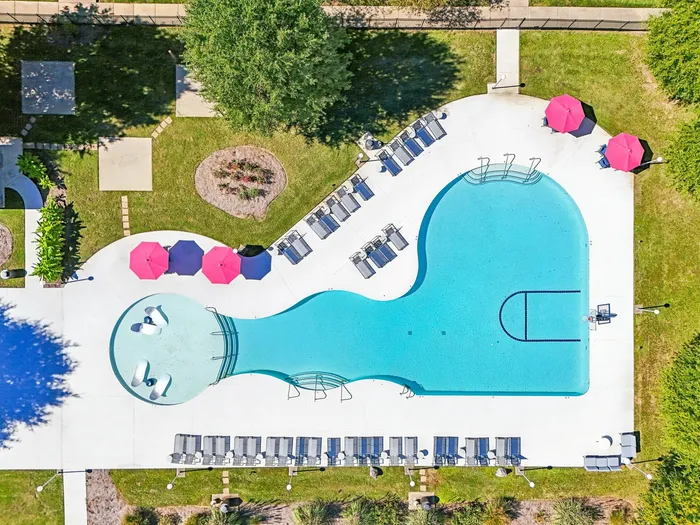 Resort-style pool with tanning ledges, lounge chairs, and shaded seating areas at The Preserve Murfreesboro.