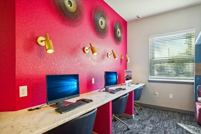 Modern computer workstations with vibrant decor and comfortable seating at The Preserve Murfreesboro.
