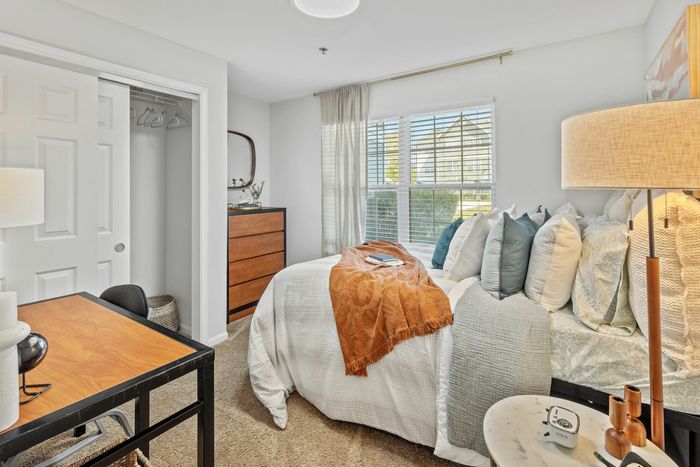 Charming bedroom with spacious closet and ceiling fan at Theater Street Apartments in Lafayette, LA