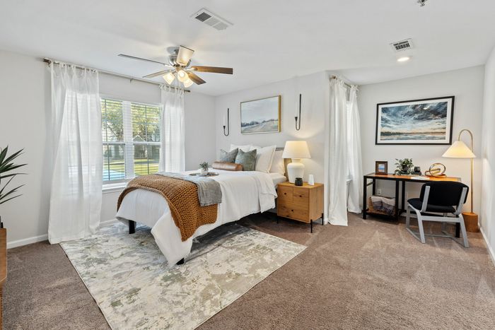 Bedroom with ample natural light and ceiling fan