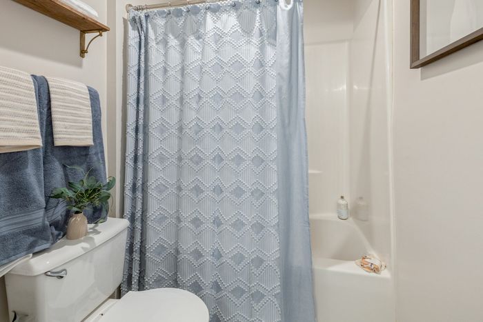 Bathroom with deluxe shower and tub at Theater Street Apartments in Lafayette, LA
