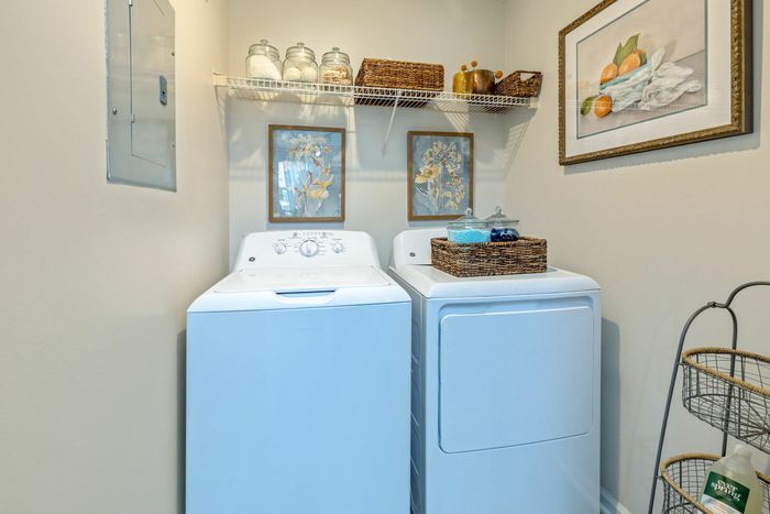 Laundry closet and full-size washer and dryer at Theater Street Apartments in Lafayette, LA