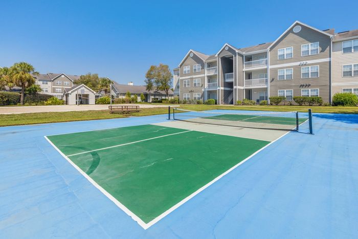 Outdoor pickle ball and sand volleyball court at Theater Street Apartments in Lafayette, LA