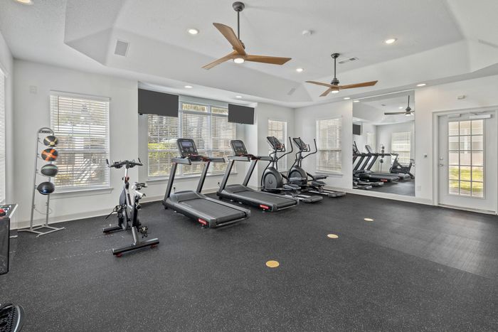 Fitness center with lots of workout machines at Theater Street Apartments in Lafayette, LA