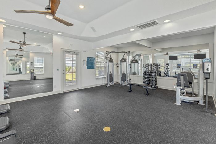 Fitness center with lots of workout machines at Theater Street Apartments in Lafayette, LA