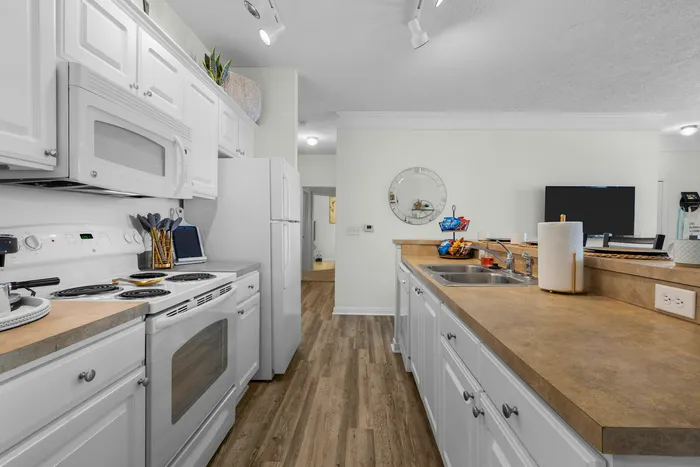 Modern kitchen with sleek white cabinets, spacious countertops, and contemporary appliances for an inviting culinary space.