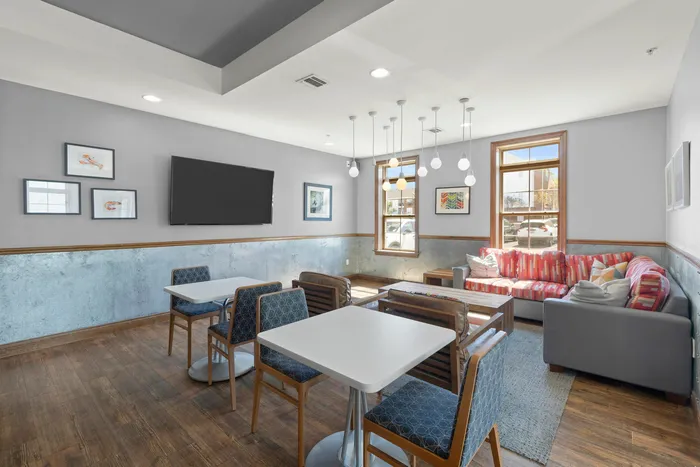 Chic and inviting communal space with modern dining tables, cozy seating area, and contemporary decor.