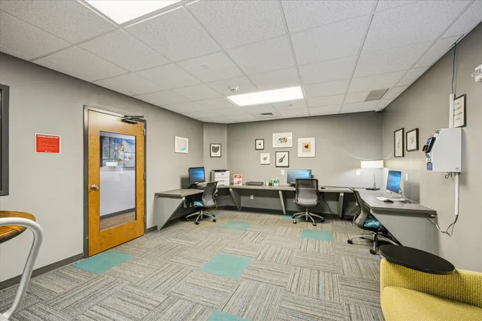 Chic modern office space with sleek desks, comfortable chairs, and stylish wall art, ideal for productivity and collaboration.