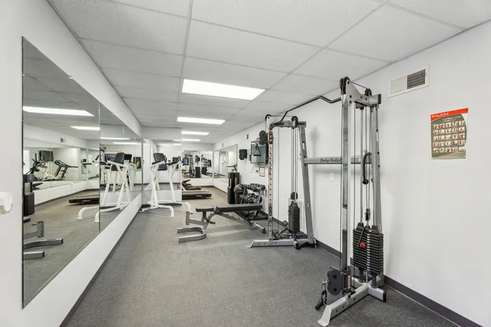 Modern fitness center equipped with state-of-the-art exercise machines and mirrored walls for a dynamic workout experience.