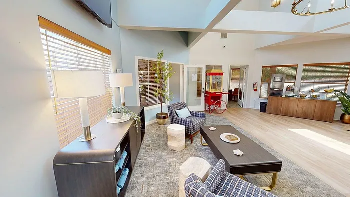Bright and inviting lounge area with modern furnishings, large windows, and an open layout, perfect for relaxation and social gatherings.