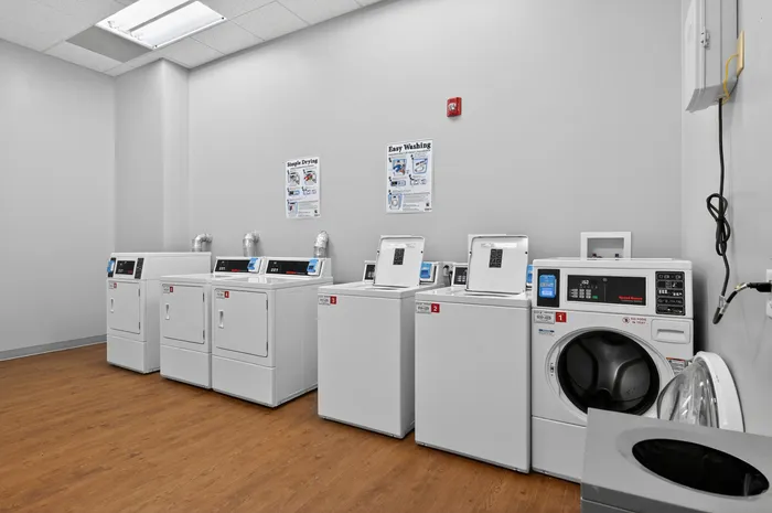 Modern laundry room with sleek washers and dryers, offering a clean and efficient space for washing clothes.