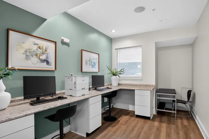 Modern home office with elegant desks, stylish decor, and abundant natural light.