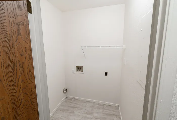 Laundry room with washer/dryer hookups, shelf storage and durable flooring &ndash; Fremont Landing Apartments