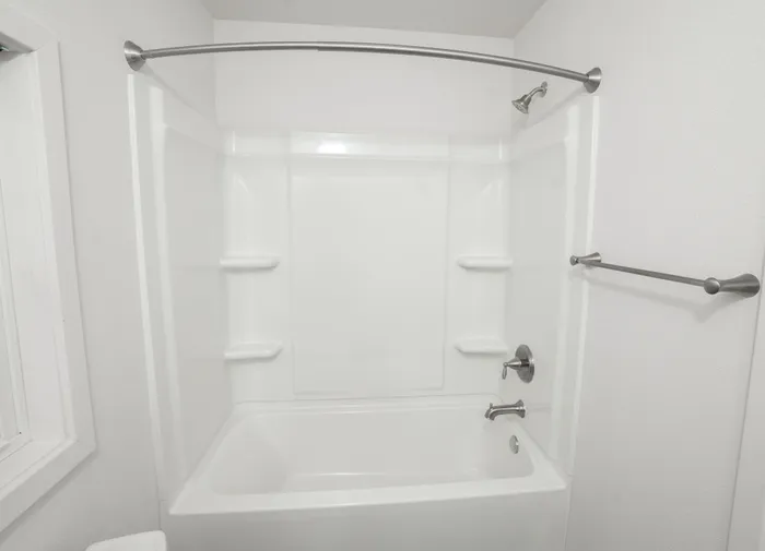 Full bathroom with tub shower combo, built in shelving, and brushed nickel fixtures in Dryden Place Townhomes