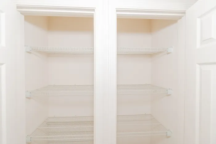 Dual storage closets at Quail Ridge East Apartments featuring built in wire shelving and ample space for pantry, linen, or household organization.