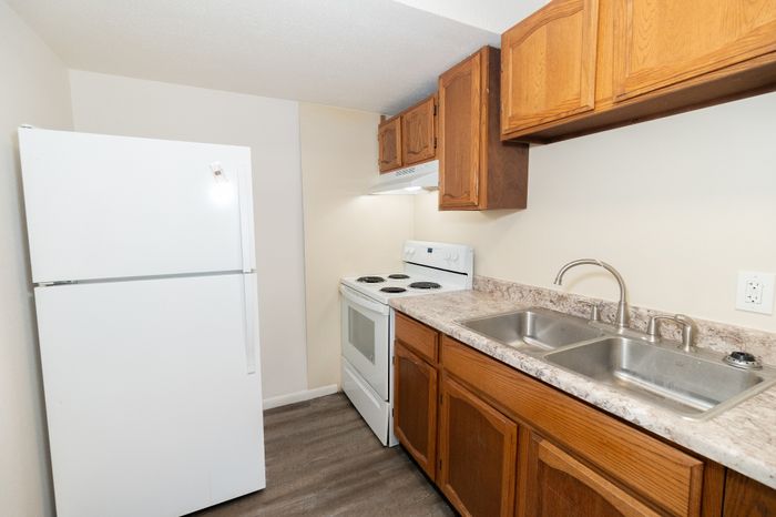 Cozy apartment kitchen with modern appliances, spacious countertops, and elegant cabinetry.