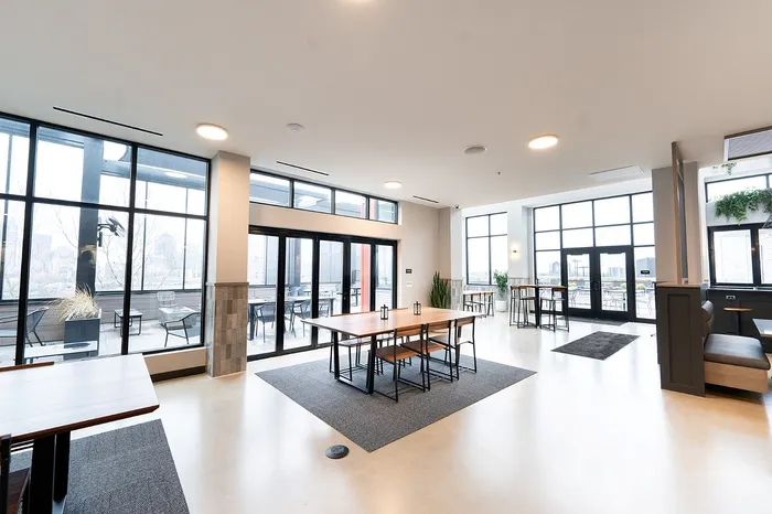 Spacious modern dining area with large windows and natural light.