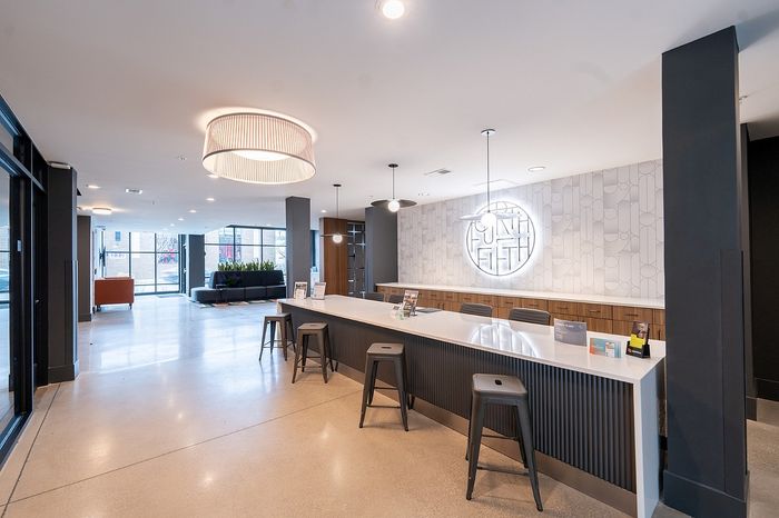 Modern lobby with sleek design, featuring a stylish reception area, contemporary lighting, and comfortable seating, ideal for a welcoming atmosphere.