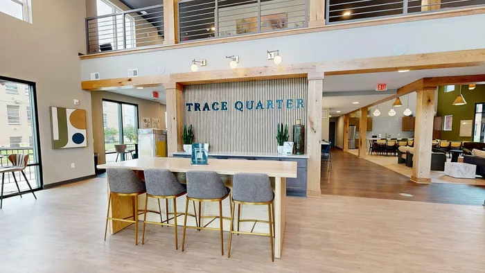 Luxurious and modern open-plan communal space at Trace Quarter, featuring stylish seating, elegant lighting, and chic decor.