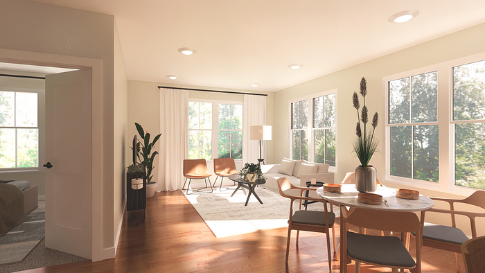 Bright and inviting living room with large windows, modern furniture, and natural wood flooring, seamlessly connected to a cozy dining area.