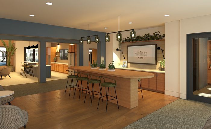 Chic communal space featuring stylish bar seating, modern kitchen, and elegant decor at The Michael.