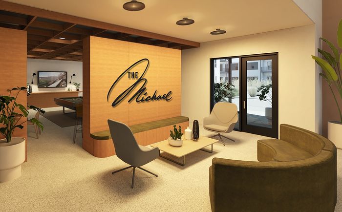 Chic and inviting apartment lobby at The Michael, featuring modern seating, large plants, and a stylish wooden accent wall.