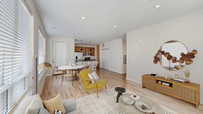 Bright and inviting open-concept living space with modern kitchen, cozy seating area, and stylish decor.