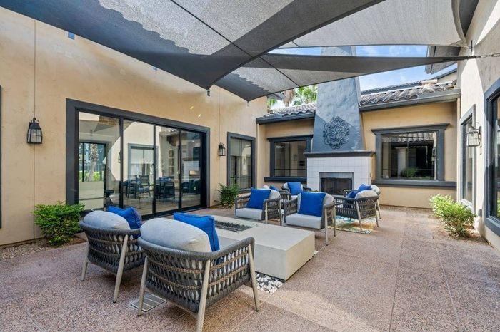 Clubhouse with fireplace and seating Lunaire Apartments | Goodyear, Arizona