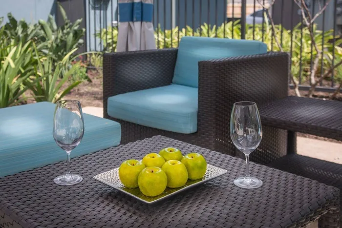Seating and tables at outdoor lounge Greenhouse Apartments In Houston