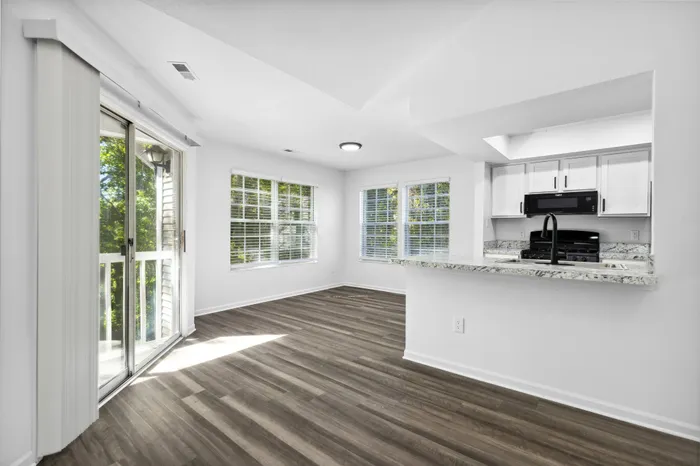 Renovated Apartment - Wood-plank flooring, sliding doors, ceiling fan in living area at  | The Residence at Turnberry | Columbus Apartments