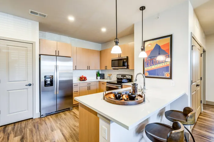 Stone countertops and modern subway tile backsplash | Peakline at Copperleaf | Aurora Apartments