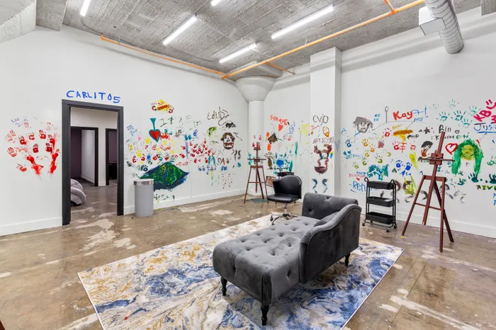 Vibrant, creative space with colorful hand-painted graffiti on walls, modern furniture, and industrial accents.