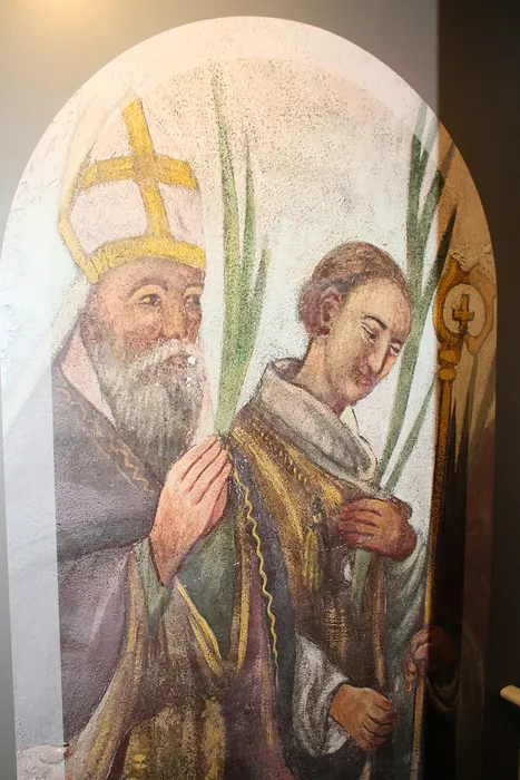 Elegant historical fresco depicting two figures in traditional religious attire with intricate details and vibrant colors.