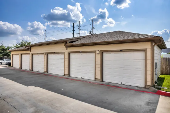 Spacious row of well-maintained garage units under a bright, clear sky, ideal for secure vehicle parking and storage.
