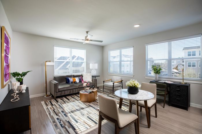Bright and inviting living room with large windows, stylish furniture, and modern decor, perfect for relaxation and entertainment.