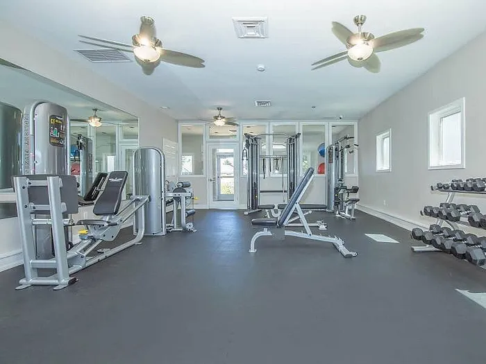 Bright, modern fitness center equipped with state-of-the-art workout machines and free weights, ideal for a healthy lifestyle.