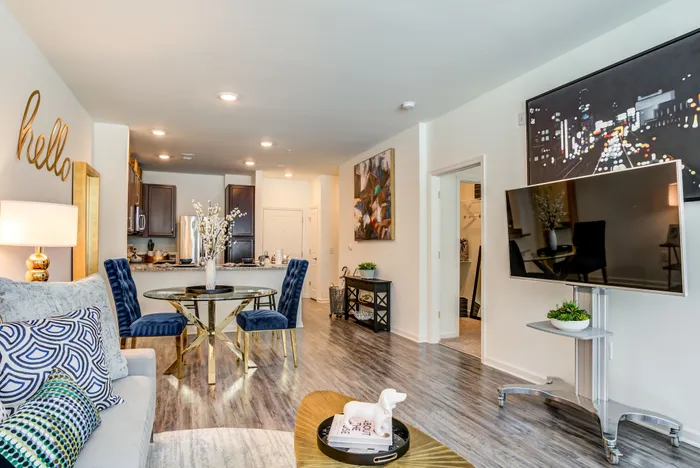 Luxurious modern apartment showcasing an elegant open-concept living area with stylish decor, plush seating, and a contemporary kitchen.