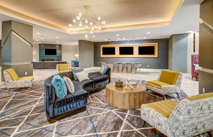 Luxurious lounge area featuring modern seating, a chic coffee table, and stylish lighting, ideal for relaxation and entertaining.