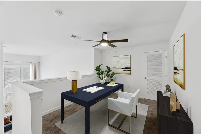 Chic home office space with a sleek blue desk, artistic decor, and ample natural light.