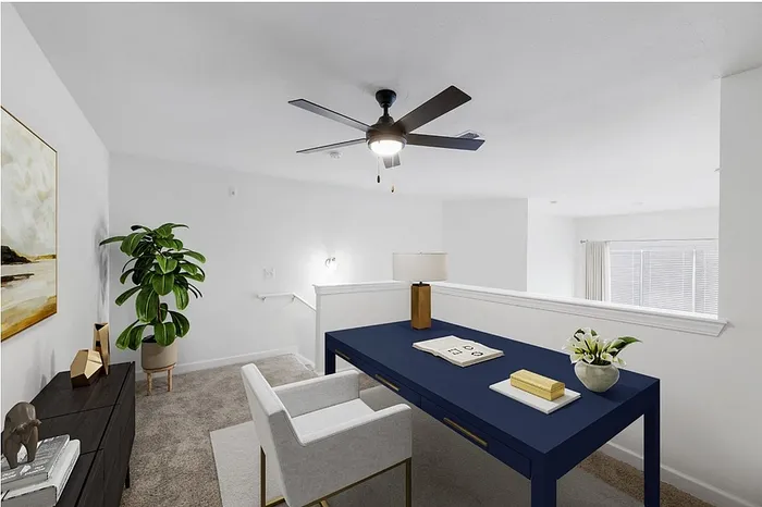 Chic home office nook with a modern blue desk, elegant decor, and abundant natural light—perfect for productivity.